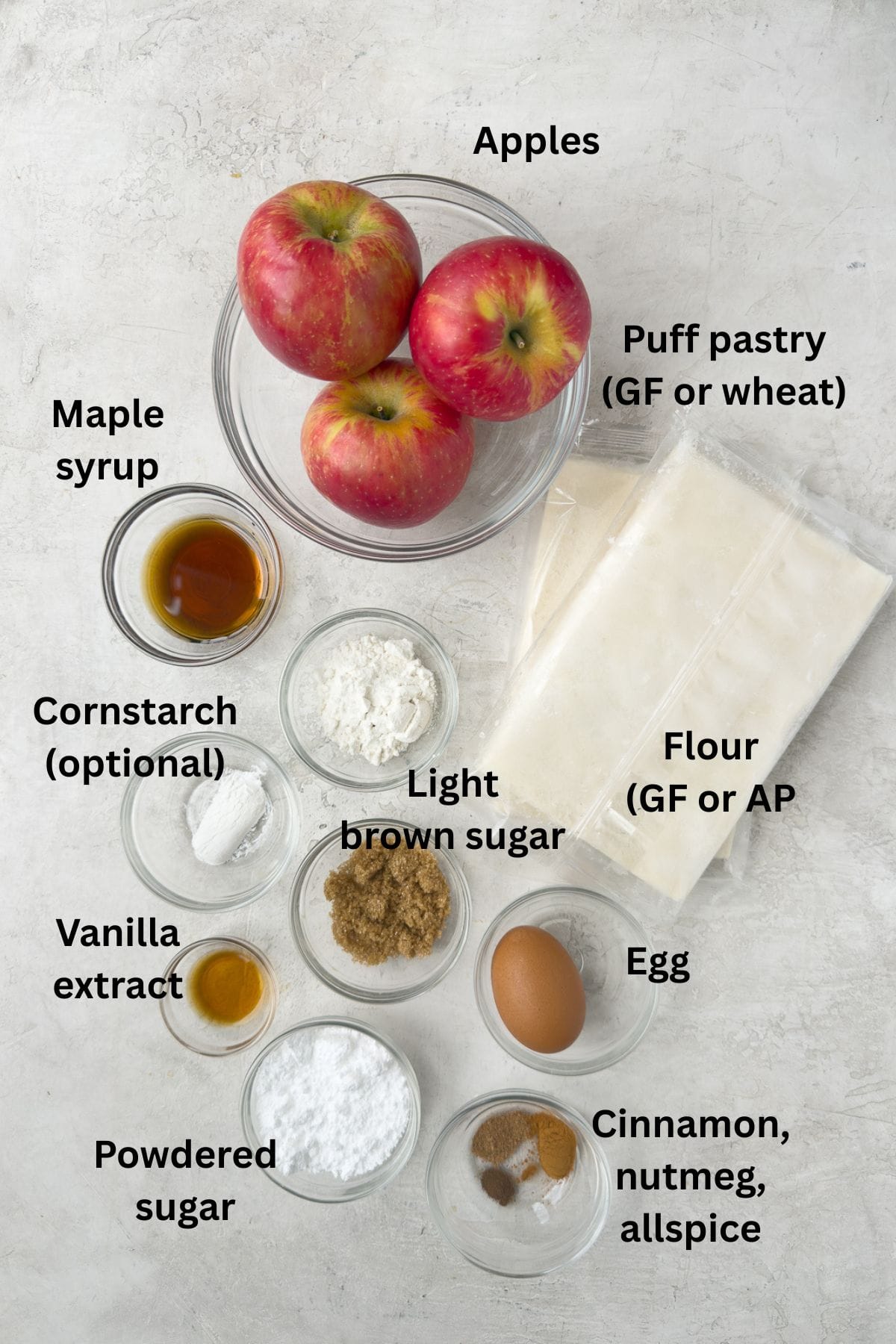 Ingredients for apple turnovers in puff pastry on a kitchen counter.