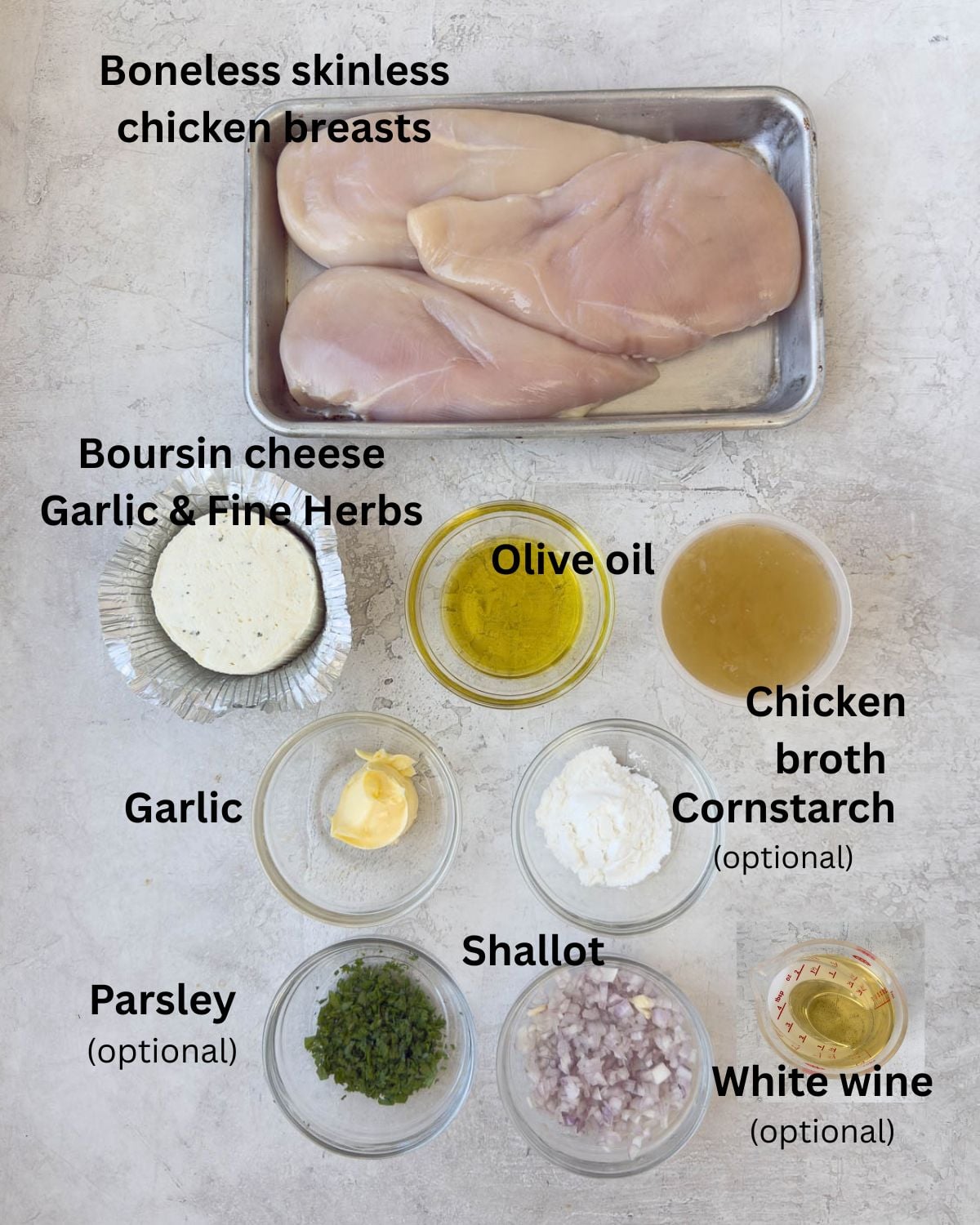 Ingredients for Boursin Chicken breasts on a kitchen counter in bowls. 