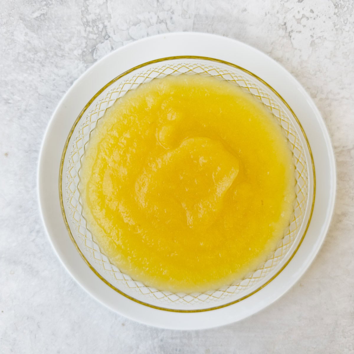 A bowl of silky smooth pureed applesauce.