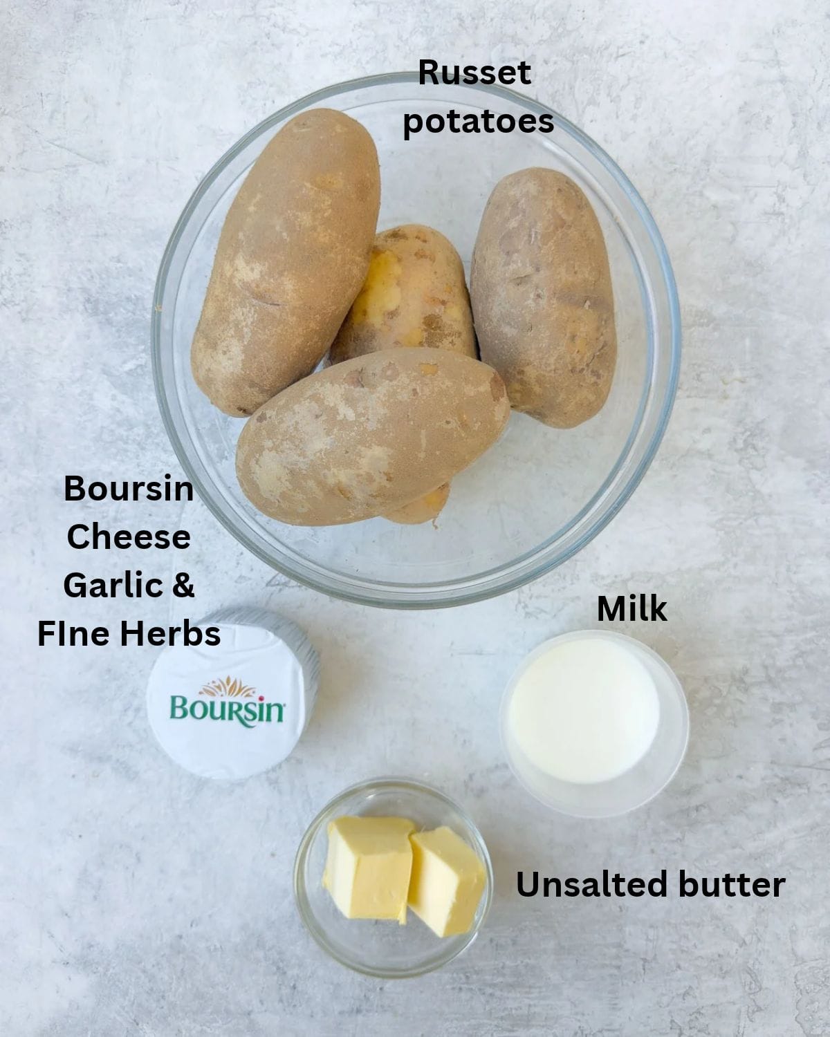 Russet potatoes, Boursin cheese, milk, and butter on the counter to make Boursin whipped potatoes.
