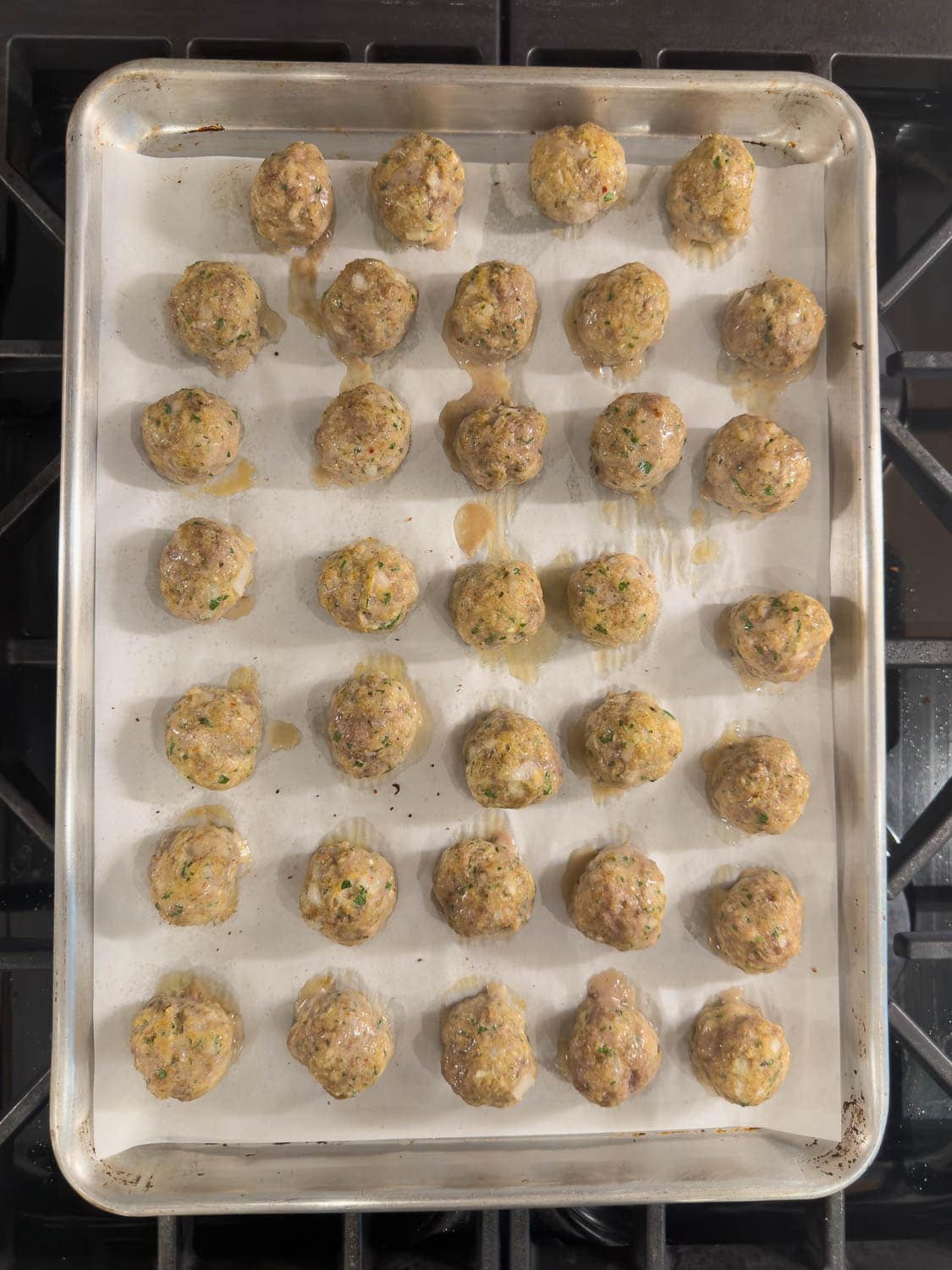 A tray of ricotta meatballs finished baking and ready to eat.