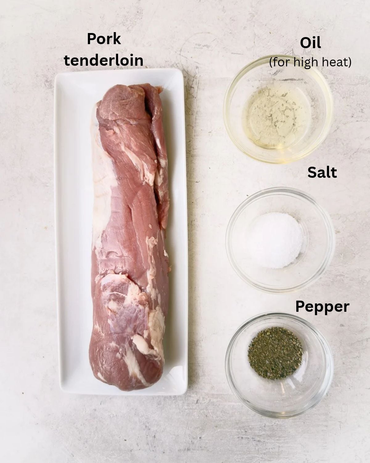 Ingredients for oven roasted pork tenderloin with pork, salt, pepper, and oil for searing.